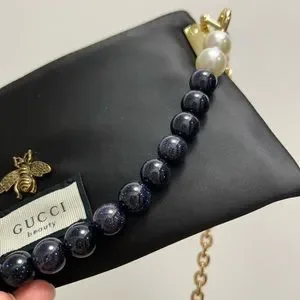 Mini Gucci perfume pouch with chain